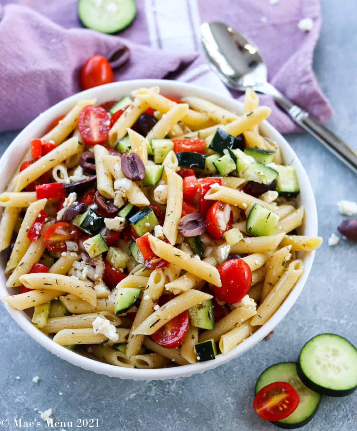 large white bowl with penne pasta salad overflowing