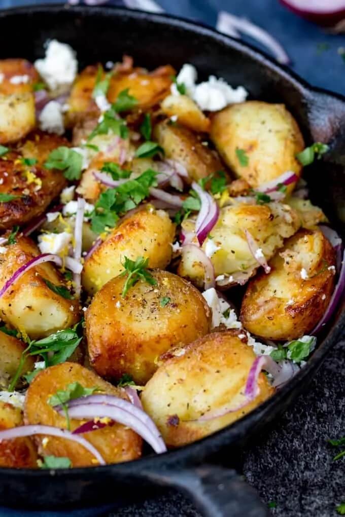 iron skillet with greek style crispy potatoes ready to eat