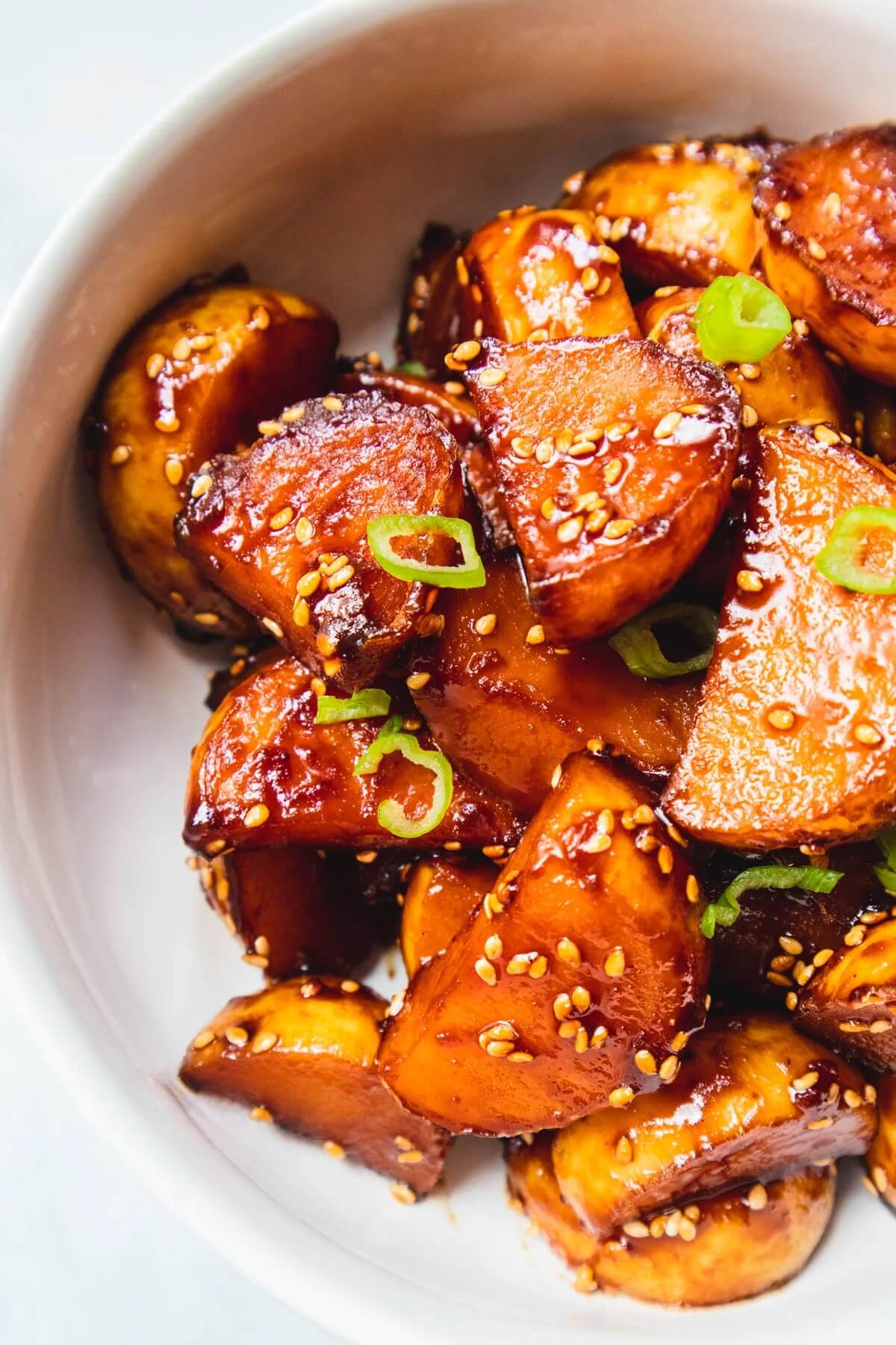 honey glazed potatoes in a large white bowl