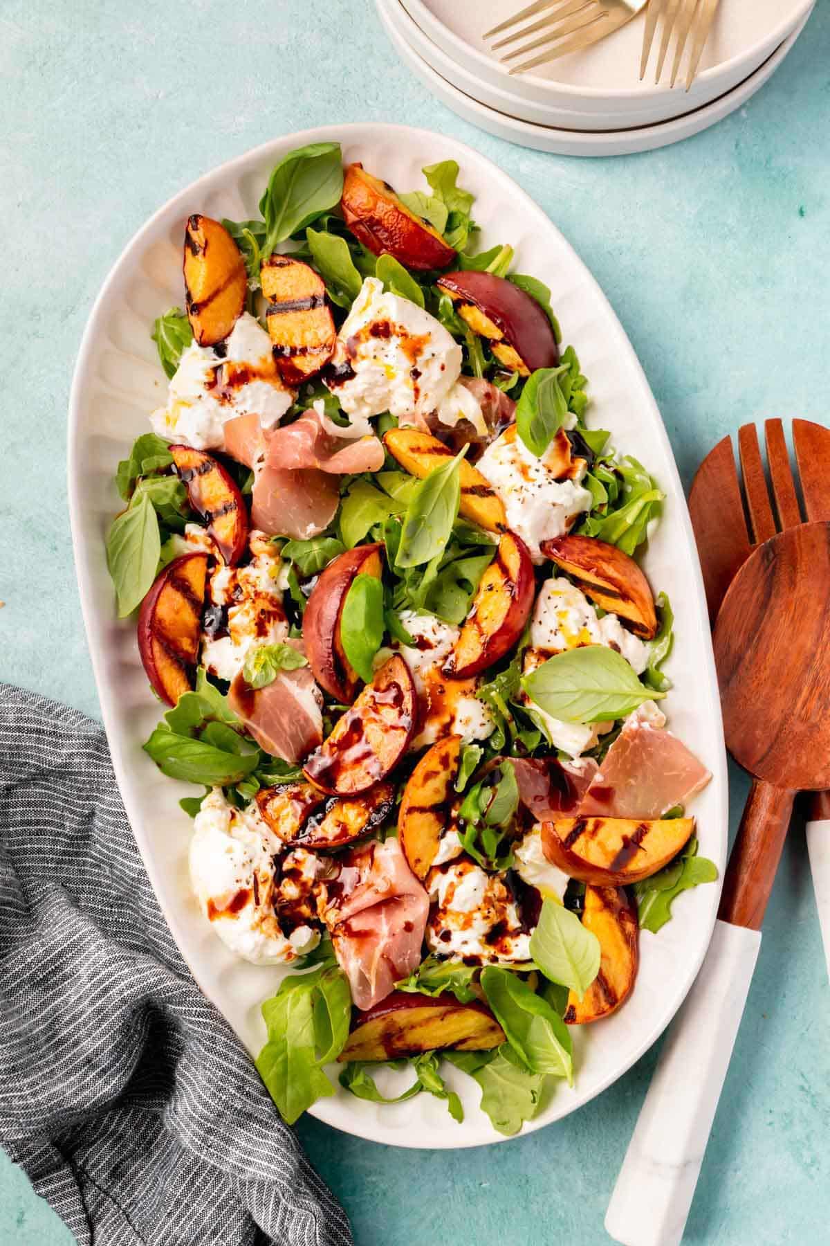 large oven serving dish with peach burrata salad
