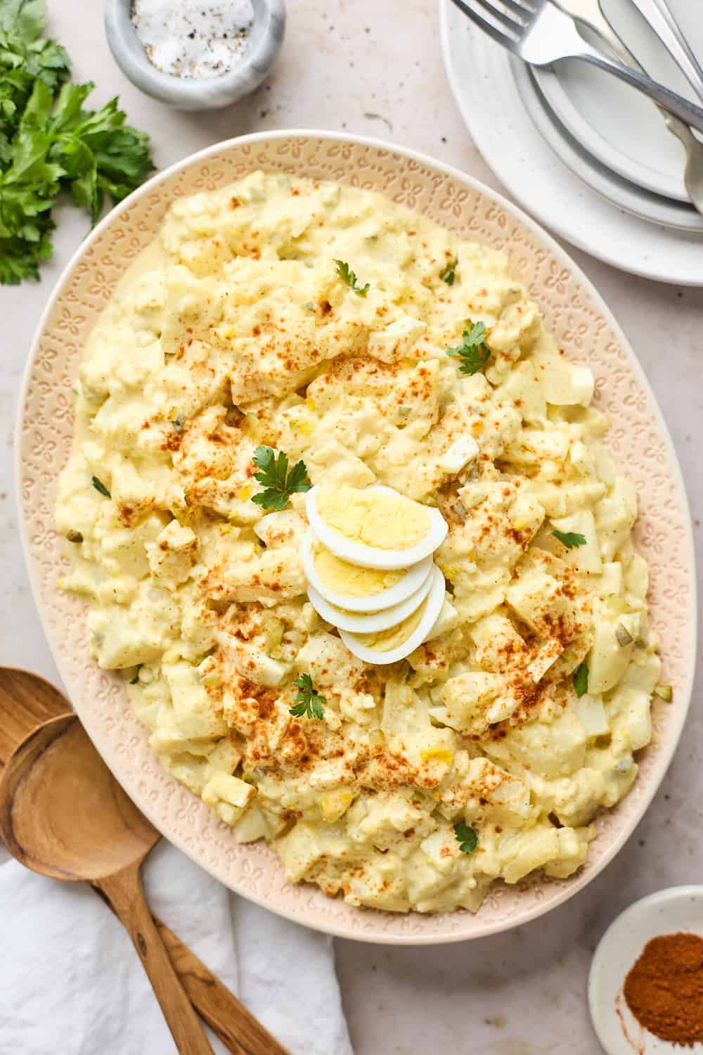 large oval dish in middle of table with southern potato salad