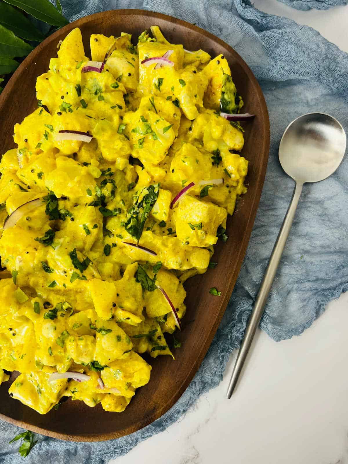 brown serving tray with curried potato salad