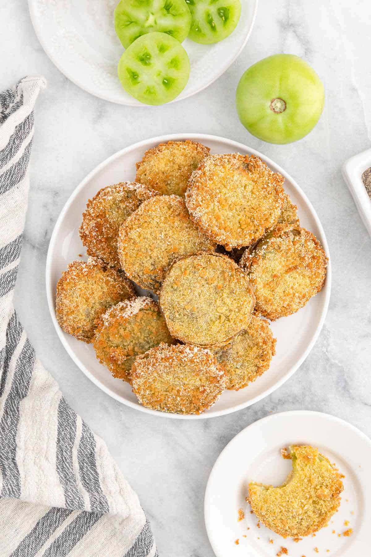 white plate with fried green tomatoes in a stack