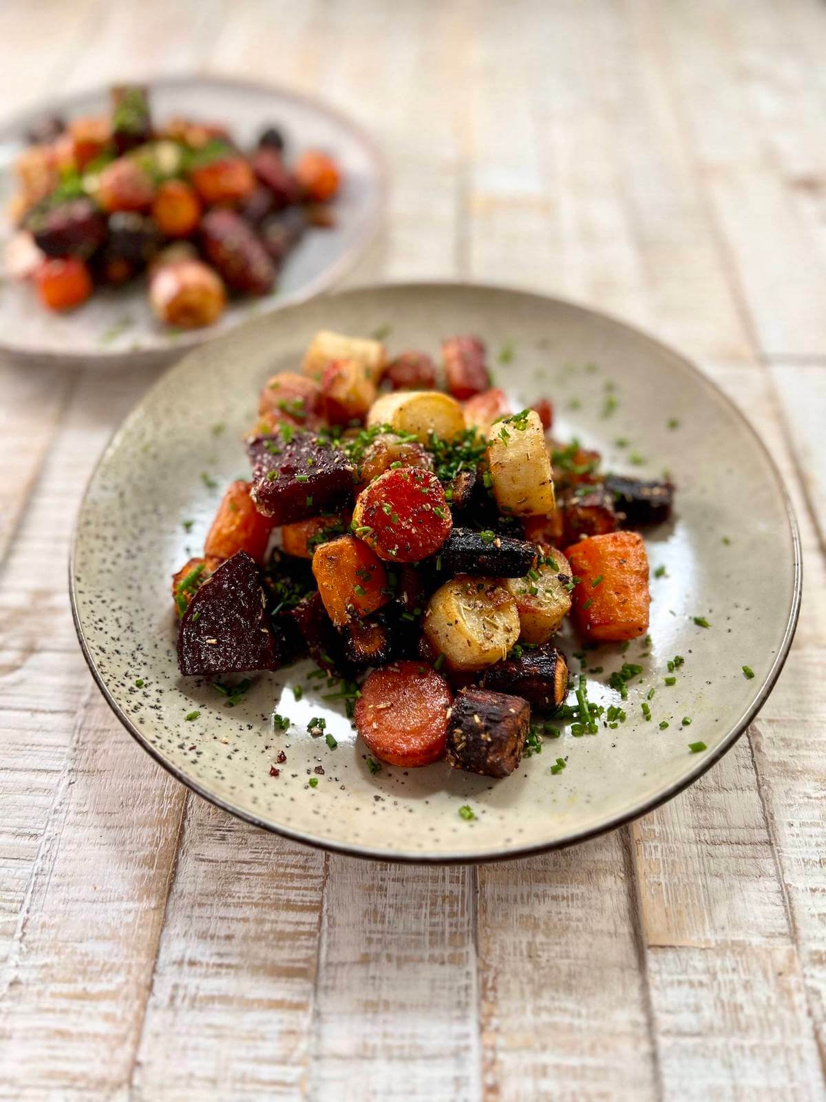 pile of oven roasted veggies on two plates