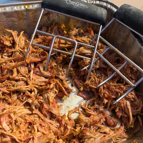 pulled pork with meat claws in a foil dish