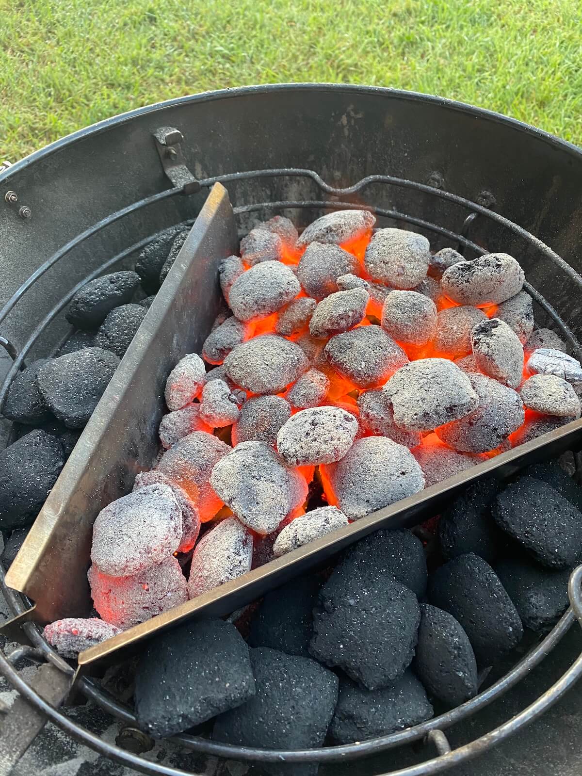 close up of briquettes in the bottom of a smoker preparing to smoke meat