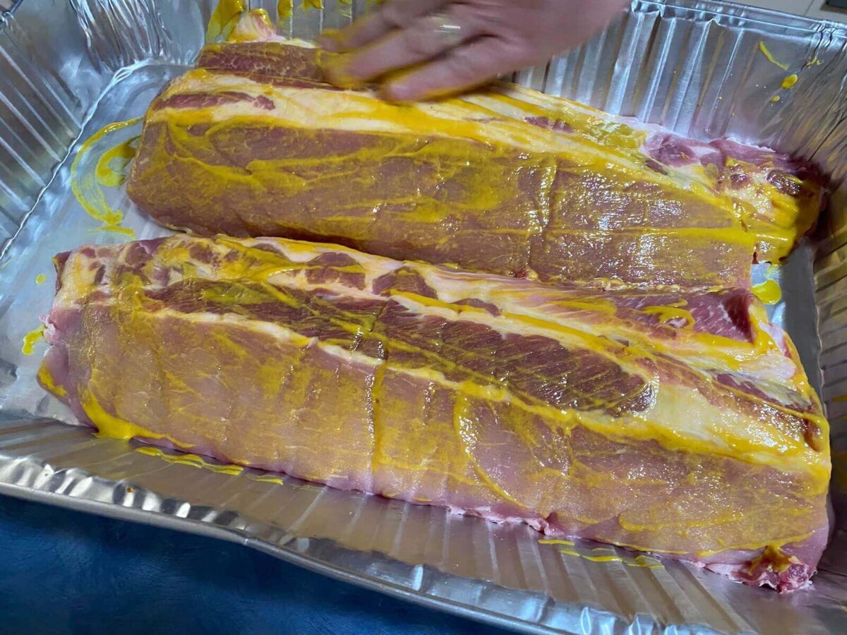 rubbing american mustard on uncooked pork ribs as a binder for dry rub