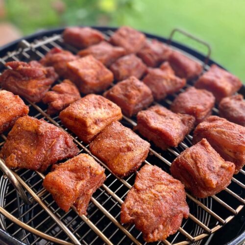 pork belly burnt ends on smoker grill rack.