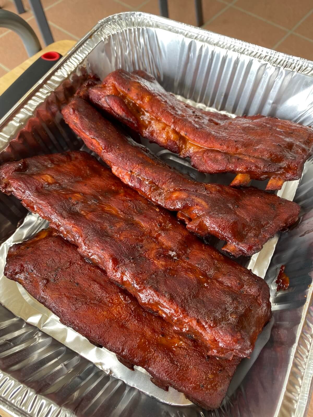 smoked pork ribs in foil tray.