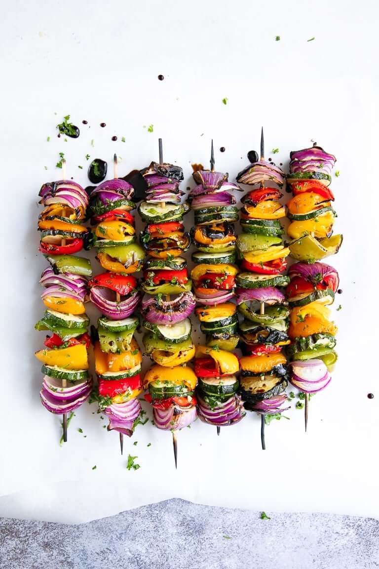 6 vegetable skewers on a white background.