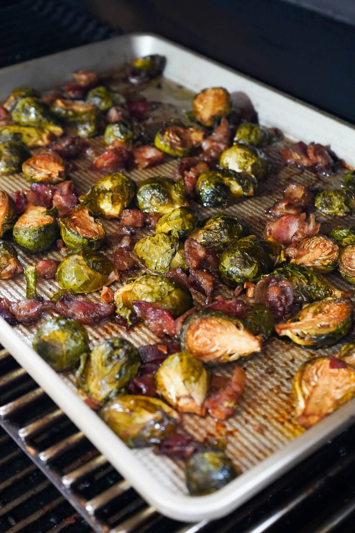 tray of roasted brussels sprouts on grill.