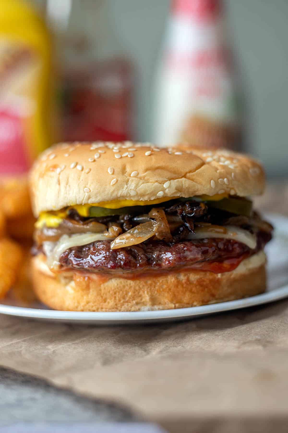 close up of burger on plate with blurred background.