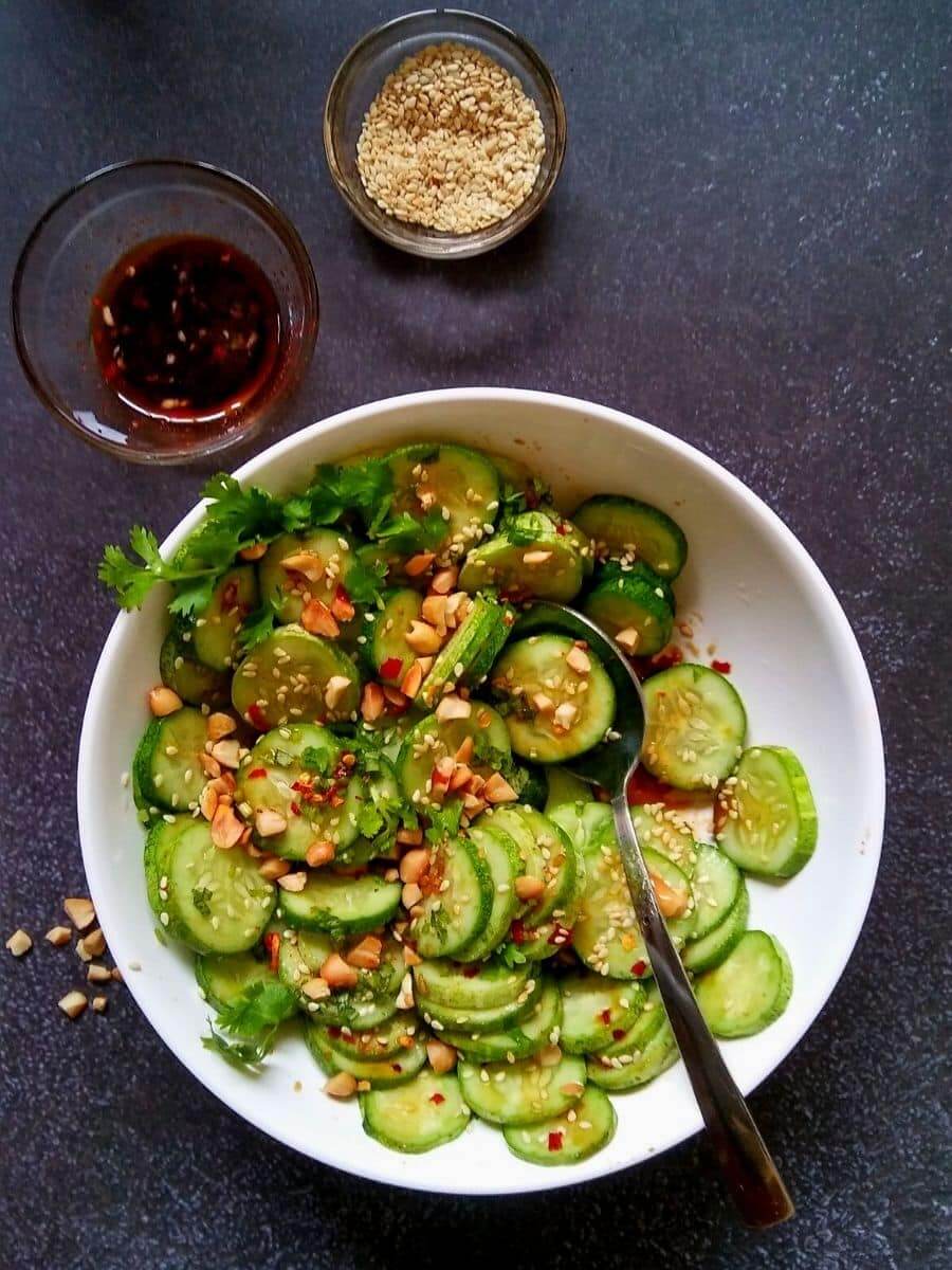 asian cucumber salad in a white bowl.