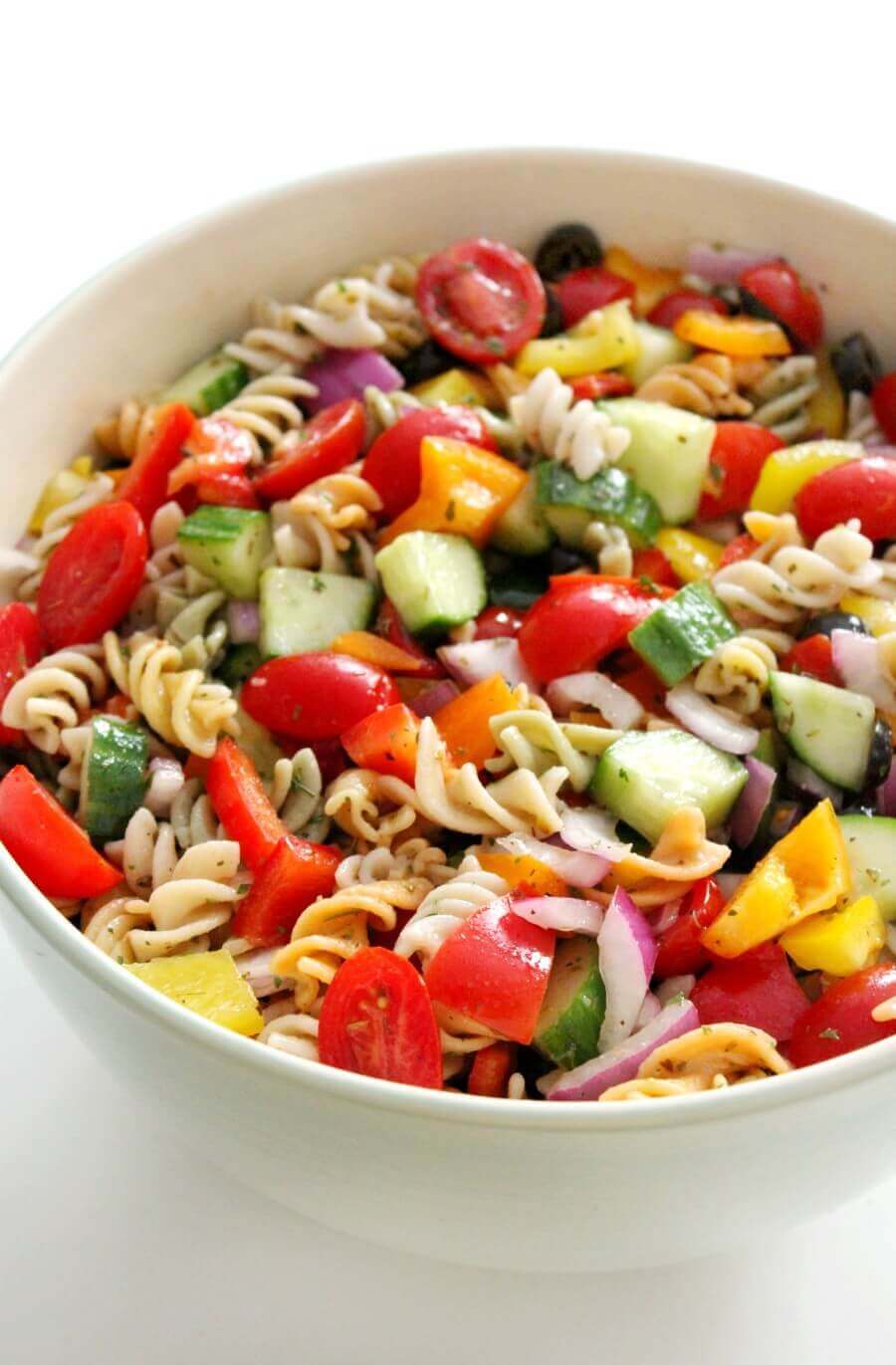 close of up large white bowl of italian pasta salad.