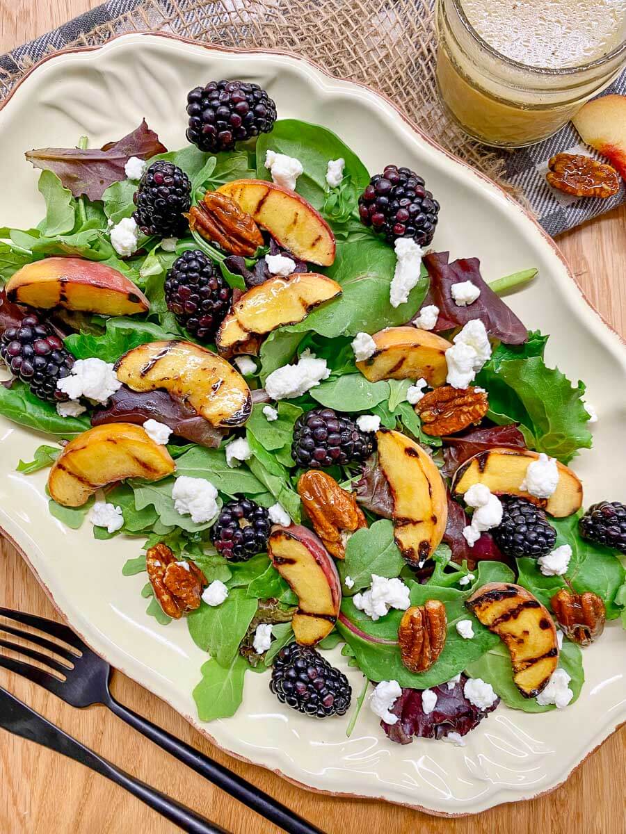 grilled peach blackberry salad on a serving platter.