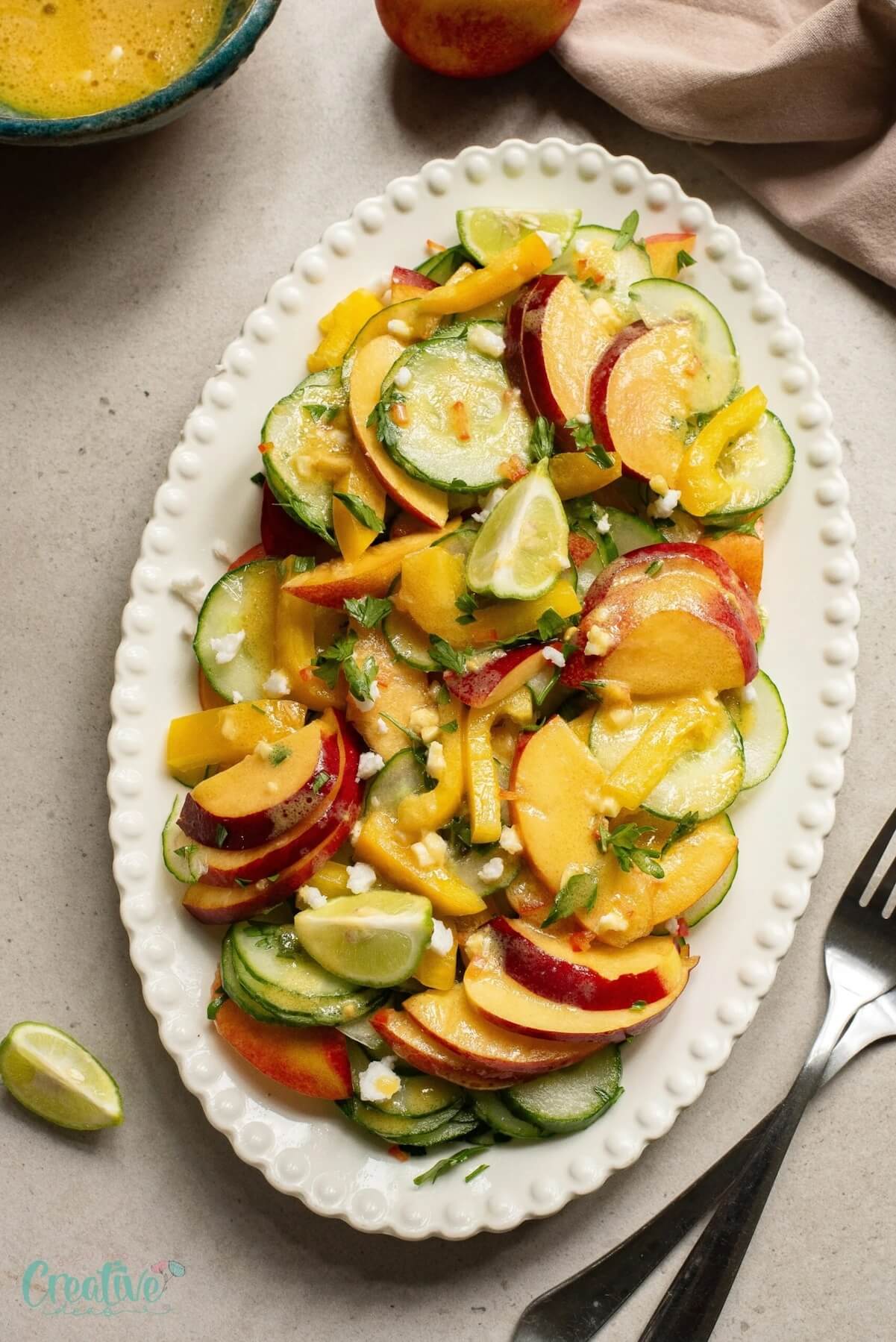 large serving platter with nectarine salad.