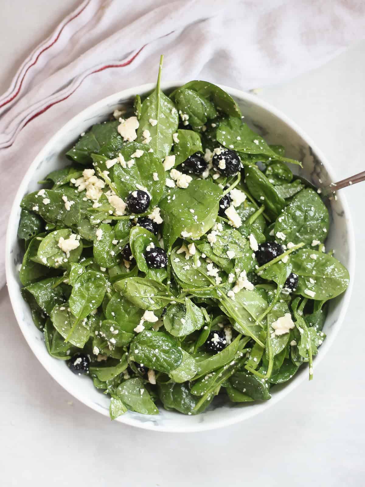 white bowl with spinach feta salad.