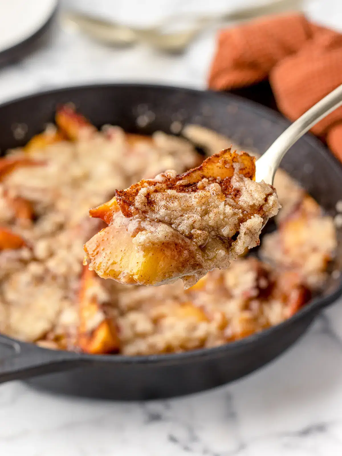 close up of peach cobbler in skillet.