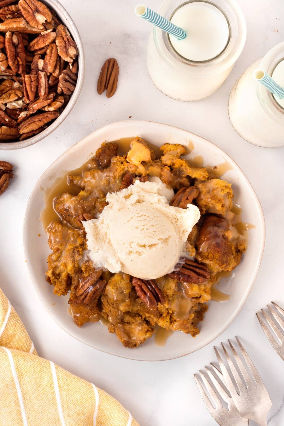 bowl of smoked bourbon pumpkin bread pudding with ice cream.