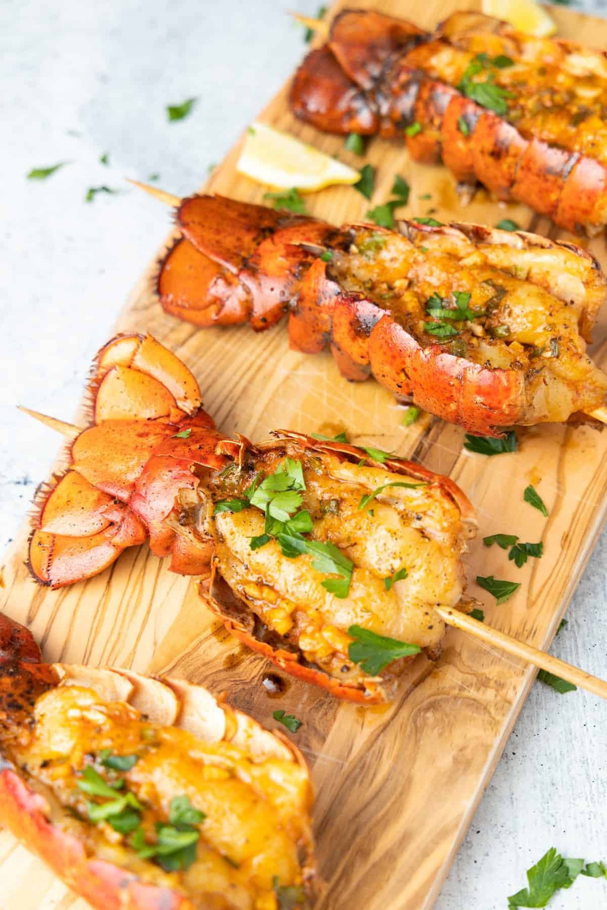 smoked lobster tails on serving board.