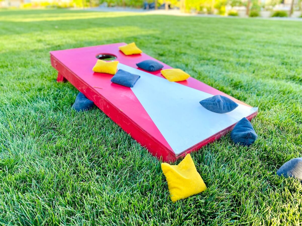 backyard corn hole board with with bean bags.